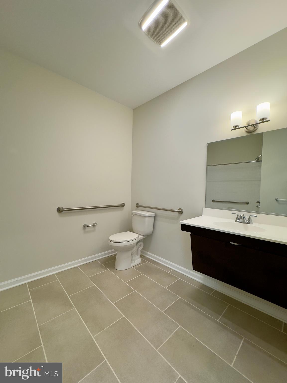 5902 Arizona Avenue, Unit 5902A Baltimore, MD 21206 - Photo 7 of 13 a spacious bathroom with a bathtub a sink and a toilet