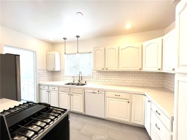 a kitchen with a sink stove and refrigerator