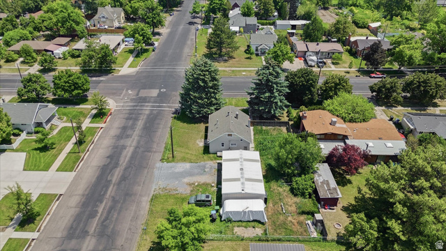 395 North 400 West Logan, UT 84321 - Photo 42 of 48 Aerial perspective showcasing a residential street with multiple properties, mature trees, and green landscaping