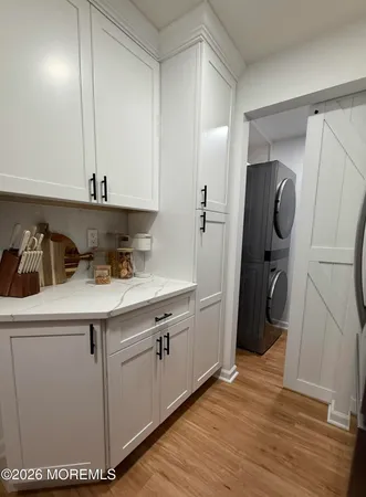 a kitchen with a sink a refrigerator and cabinets