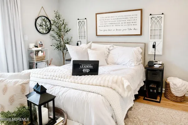 a bedroom with a bed and a chandelier