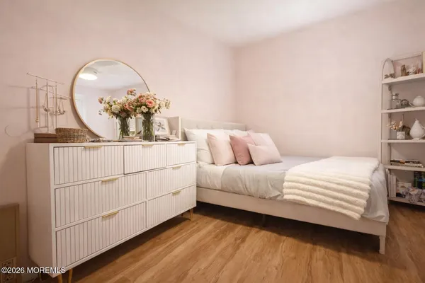 a bedroom with a bed and a mirror