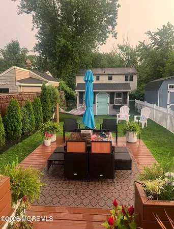 a view of house with backyard outdoor seating and green space