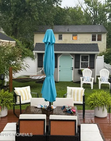a front view of house with outdoor seating and trees