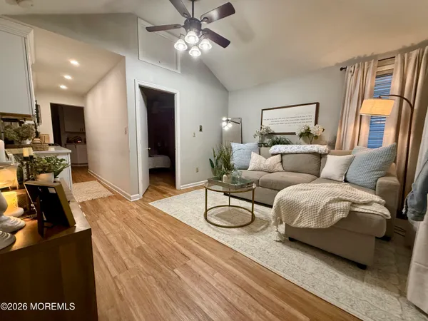a living room with furniture and a chandelier