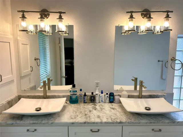 a bathroom with a sink vanity and a mirror