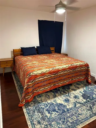 a bedroom with a bed and a mirror