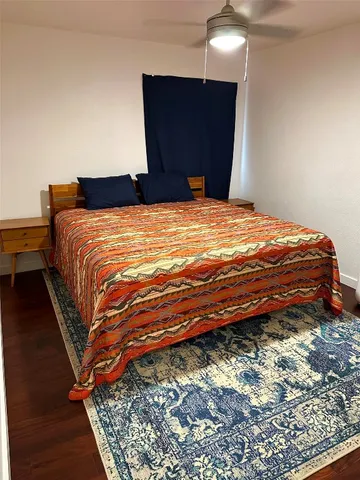 a bedroom with a bed and a mirror