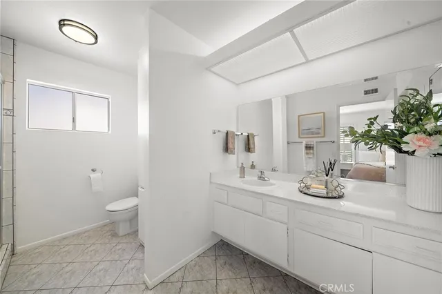 a view of a terrace with lawn chairs