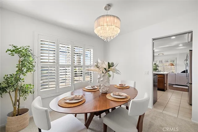 a living room with furniture and a dining table