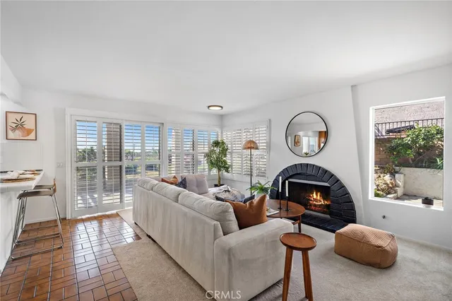 a kitchen with a refrigerator a stove top oven a sink a dining table and chairs with wooden floor