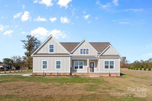 a front view of a house with a garden and patio