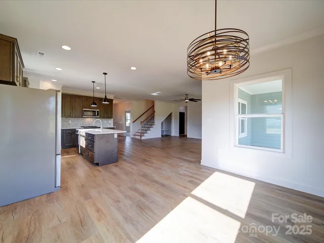 a view of a kitchen with a sink stainless steel appliances and cabinets