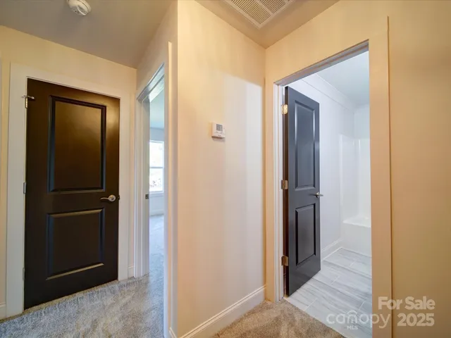 a view of a hallway with cabinets