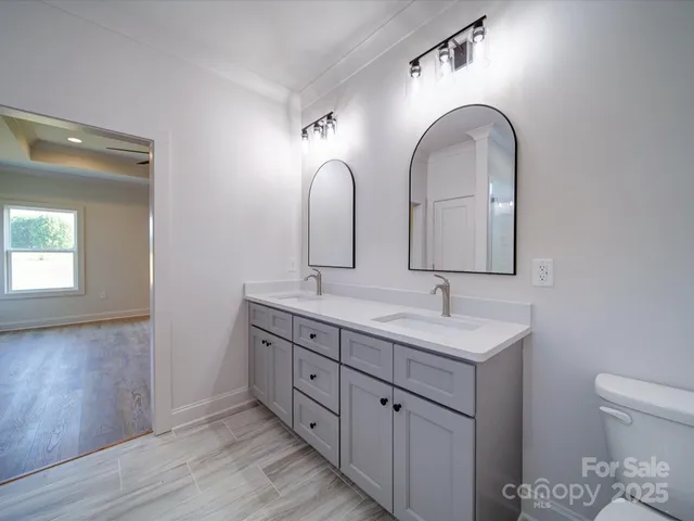 a bathroom with 2 sink and a mirror