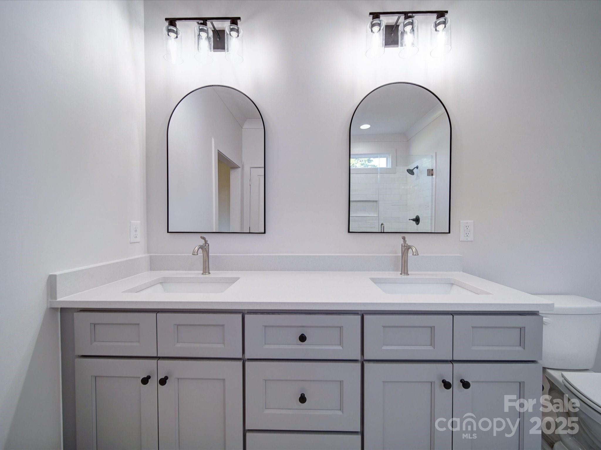 220 Lawyers Road Monroe, NC 28110 - Photo 23 of 36 a bathroom with double sink and a mirror