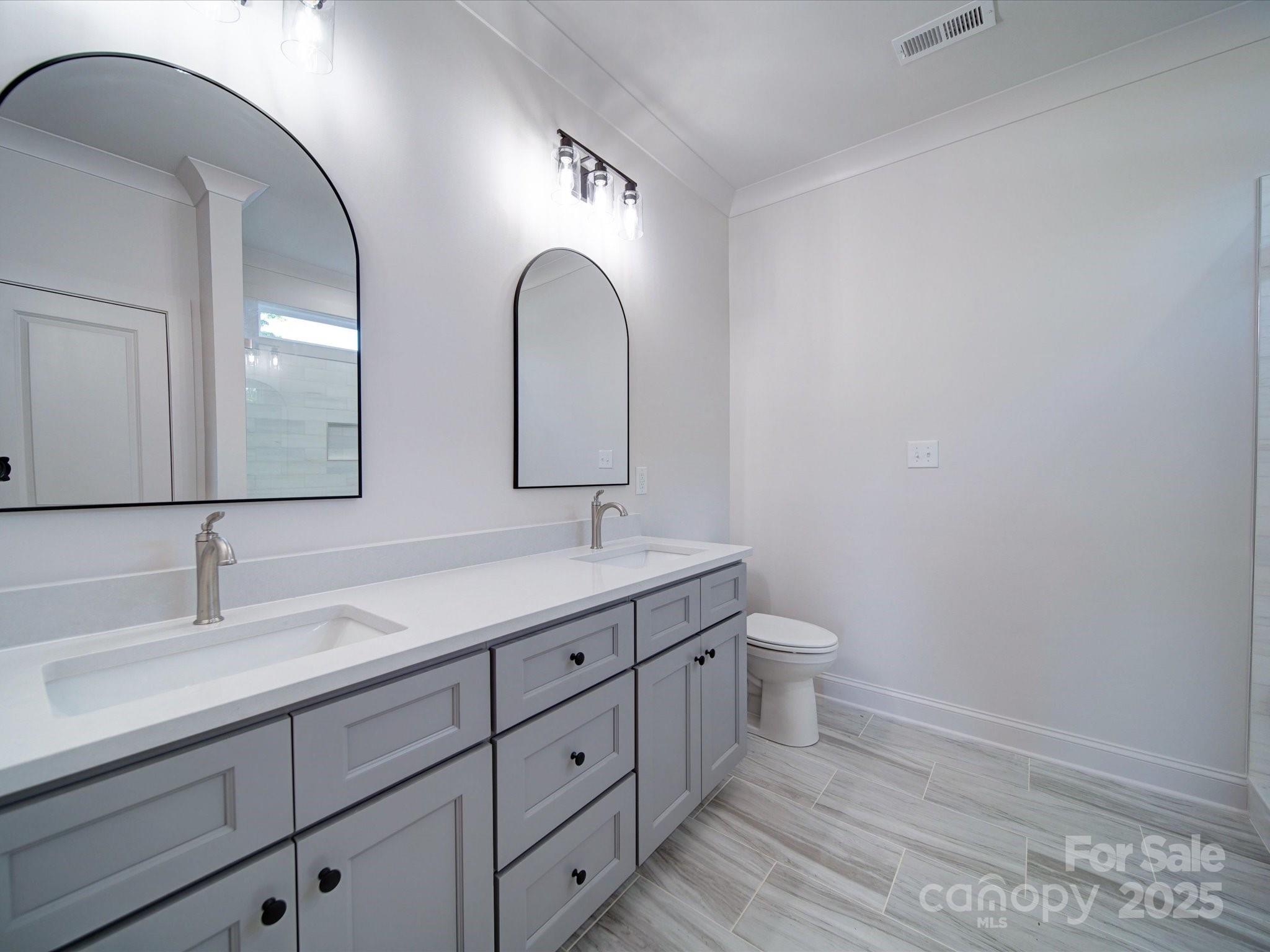 220 Lawyers Road Monroe, NC 28110 - Photo 24 of 36 a spacious bathroom with a double vanity sink and a mirror