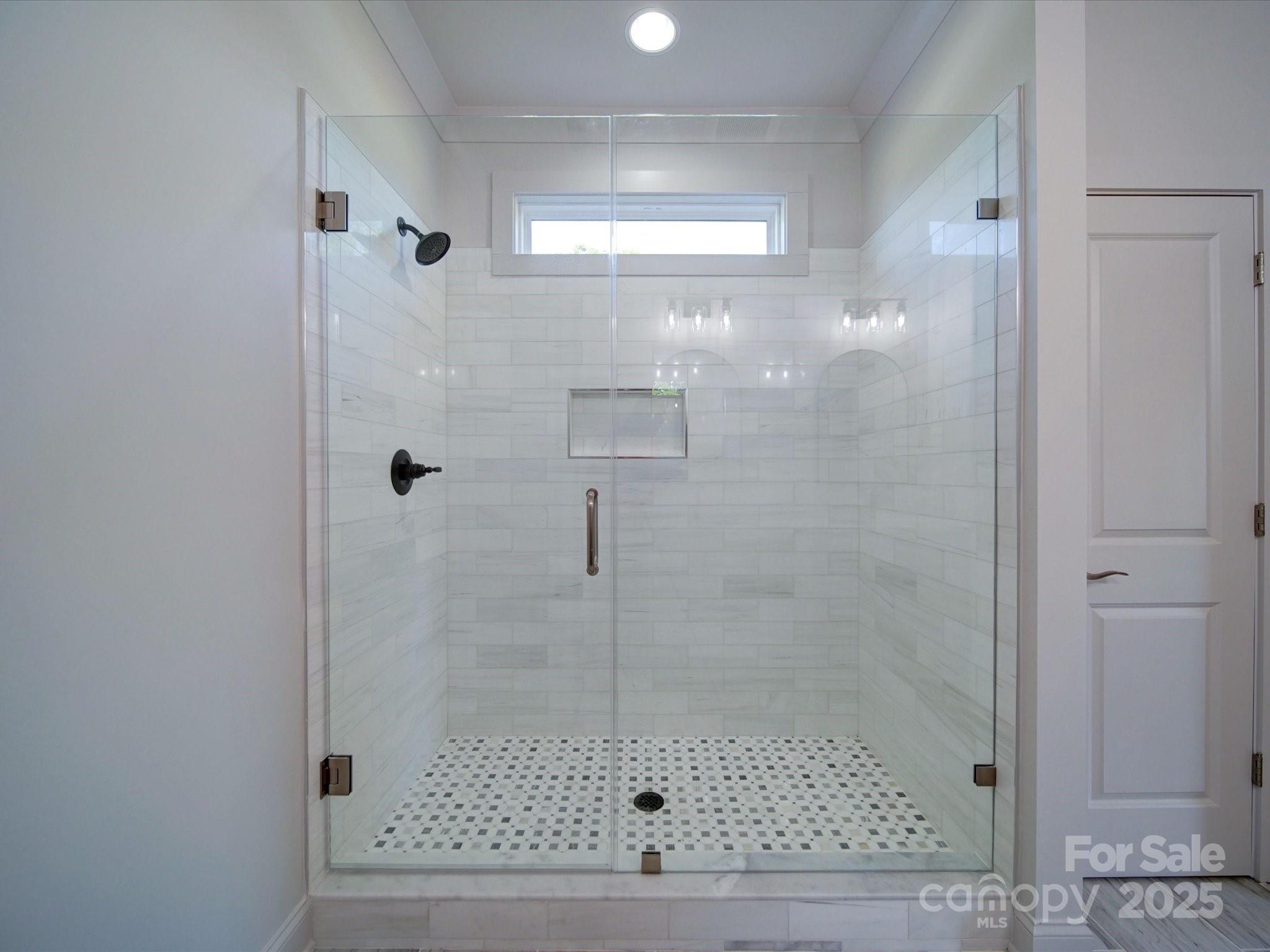 220 Lawyers Road Monroe, NC 28110 - Photo 25 of 36 a bathroom with a glass shower door