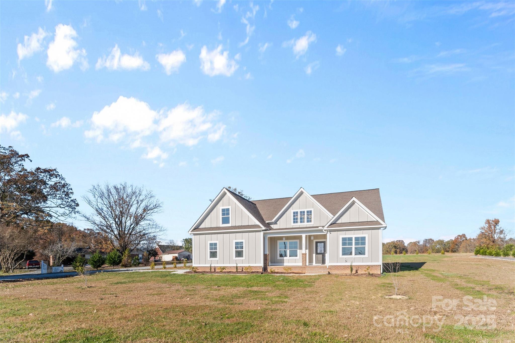220 Lawyers Road Monroe, NC 28110 - Photo 3 of 36 a front view of a house with a yard and garage