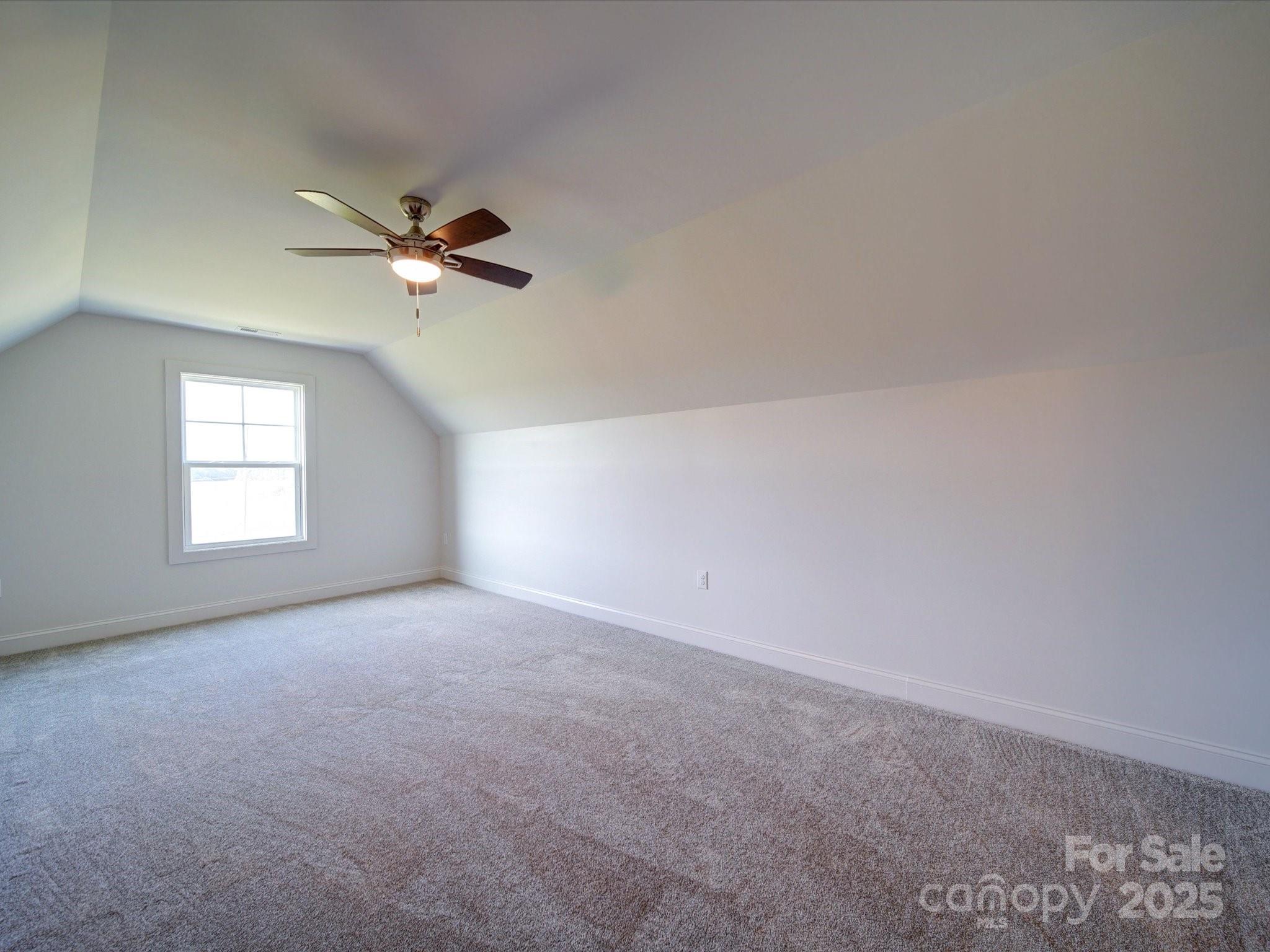 220 Lawyers Road Monroe, NC 28110 - Photo 32 of 36 an empty room with a window and a ceiling fan