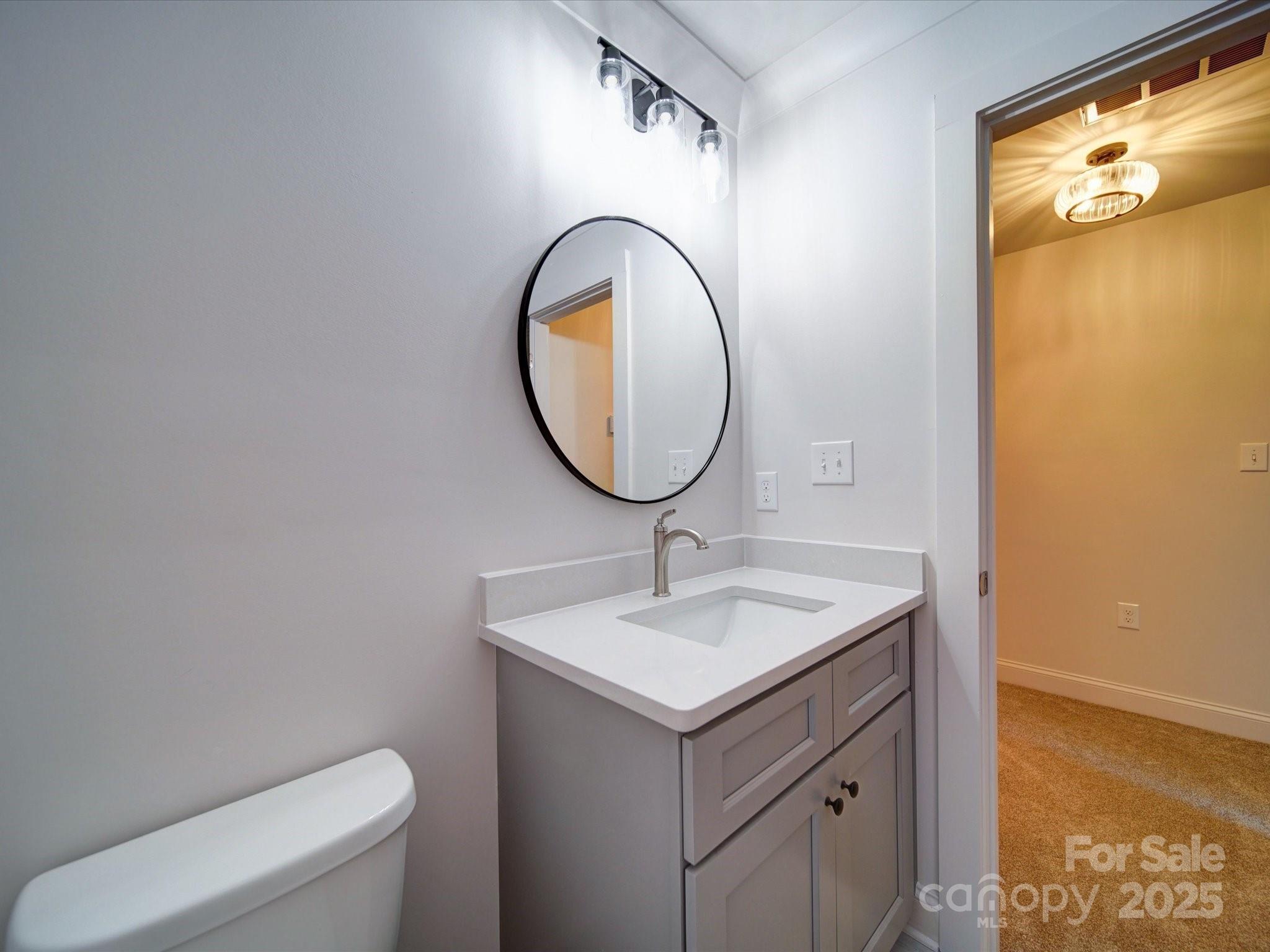 220 Lawyers Road Monroe, NC 28110 - Photo 35 of 36 a bathroom with a sink mirror vanity and toilet