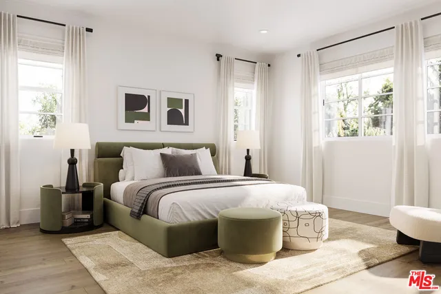 a spacious bedroom with a bed and wooden floor