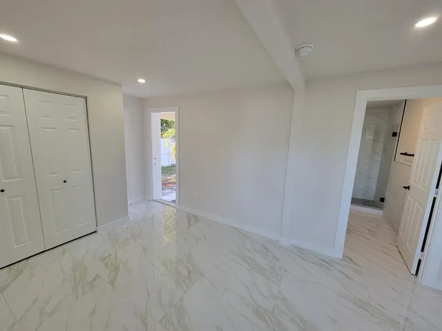 a view of an empty room and wooden floor