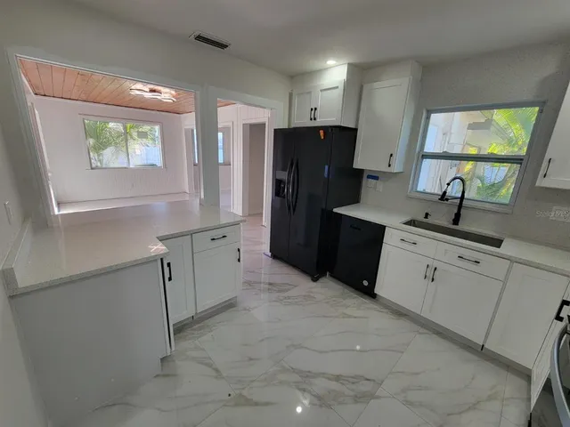 a kitchen with a refrigerator and a sink