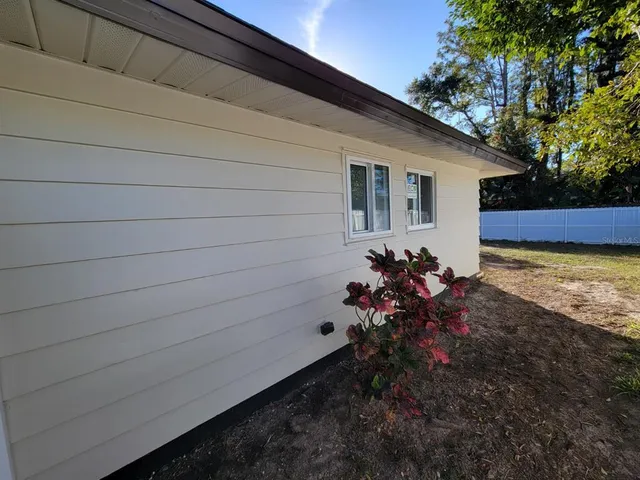 a view of a house with a backyard