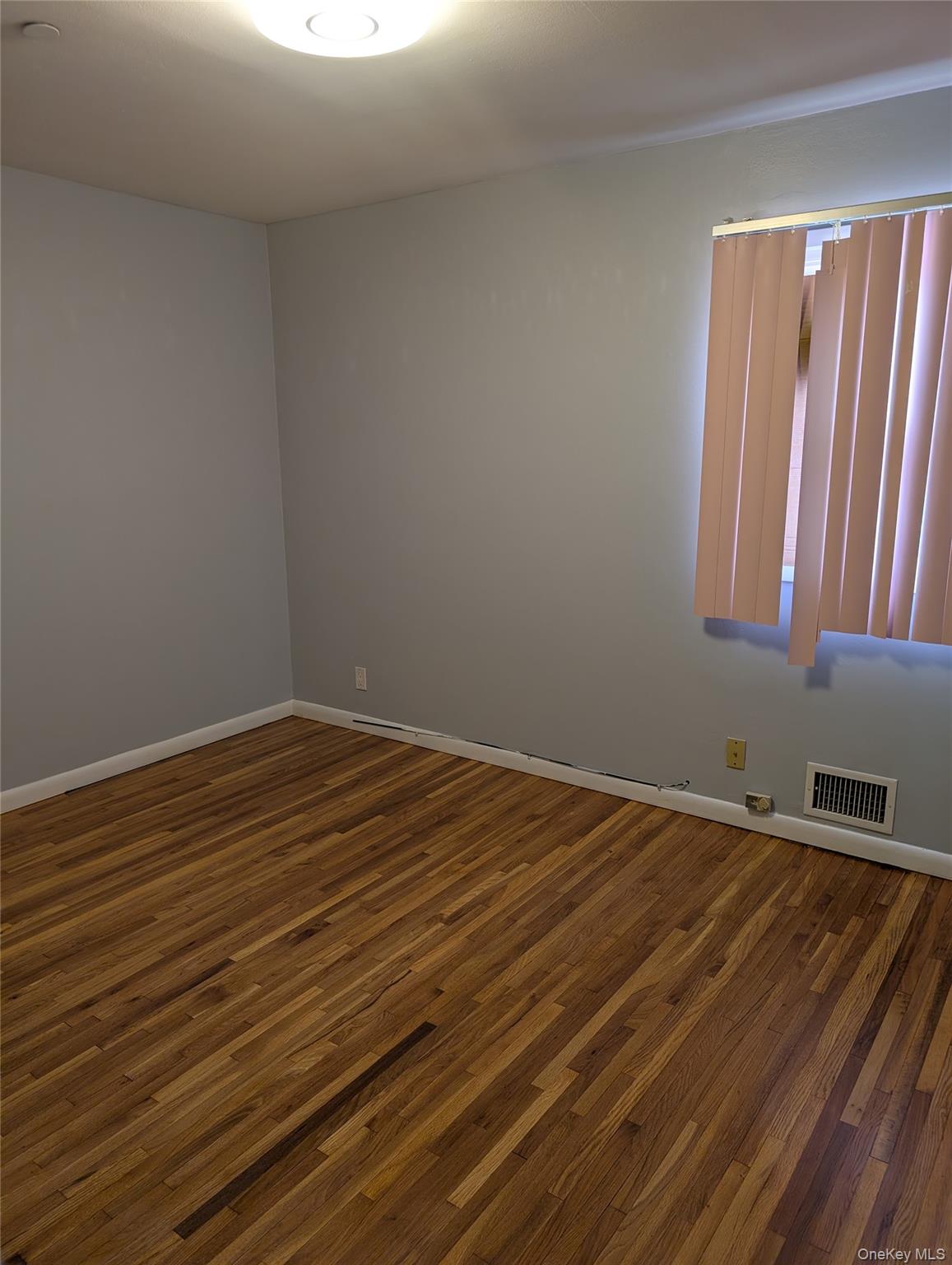 143-47 228th Street Queens, NY 11413 - Photo 18 of 18 a view of wooden floor and windows in a room