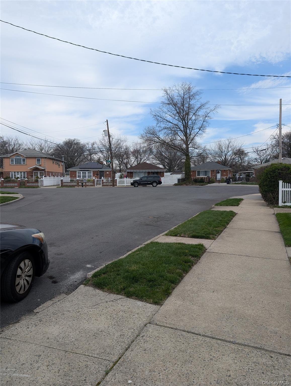 143-47 228th Street Queens, NY 11413 - Photo 3 of 18 a view of a street with a car parked in the road