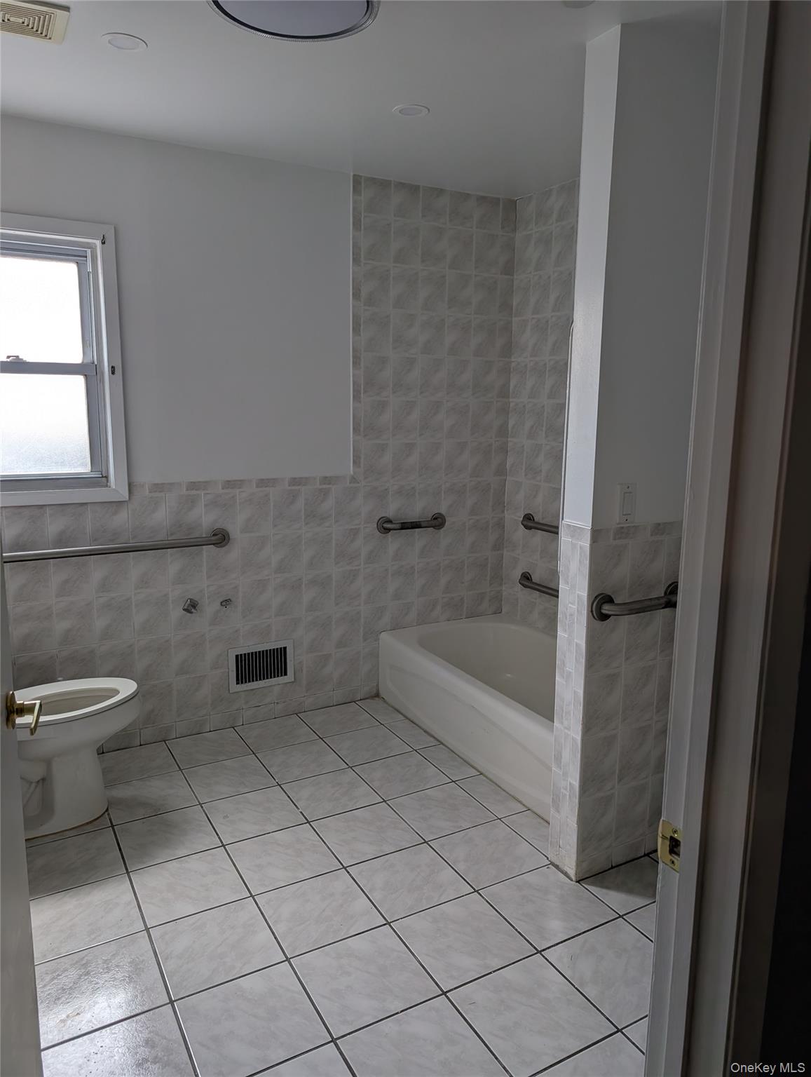 143-47 228th Street Queens, NY 11413 - Photo 5 of 18 a bathroom with a toilet and a bathtub