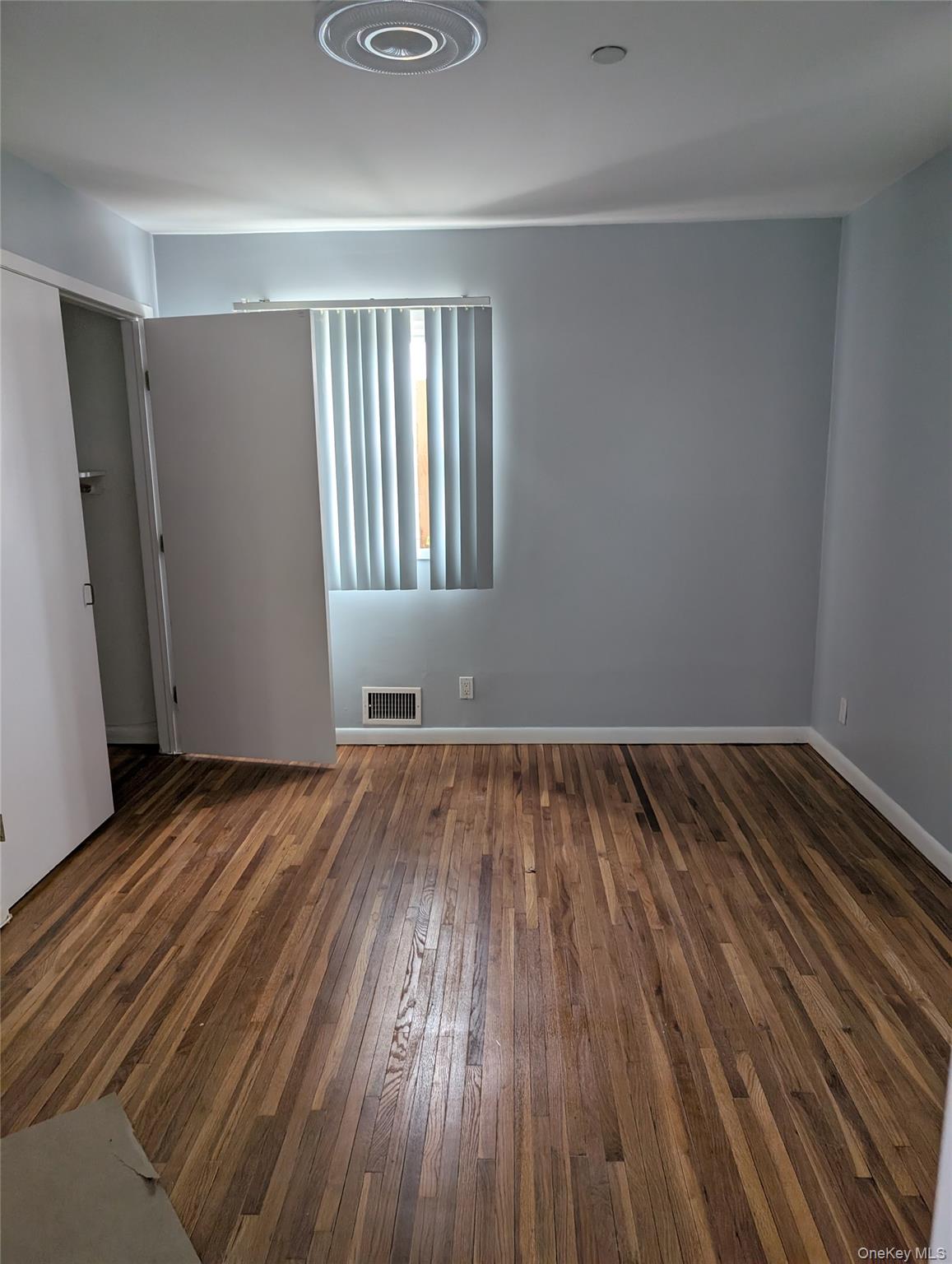 143-47 228th Street Queens, NY 11413 - Photo 7 of 18 a view of wooden floor in a room
