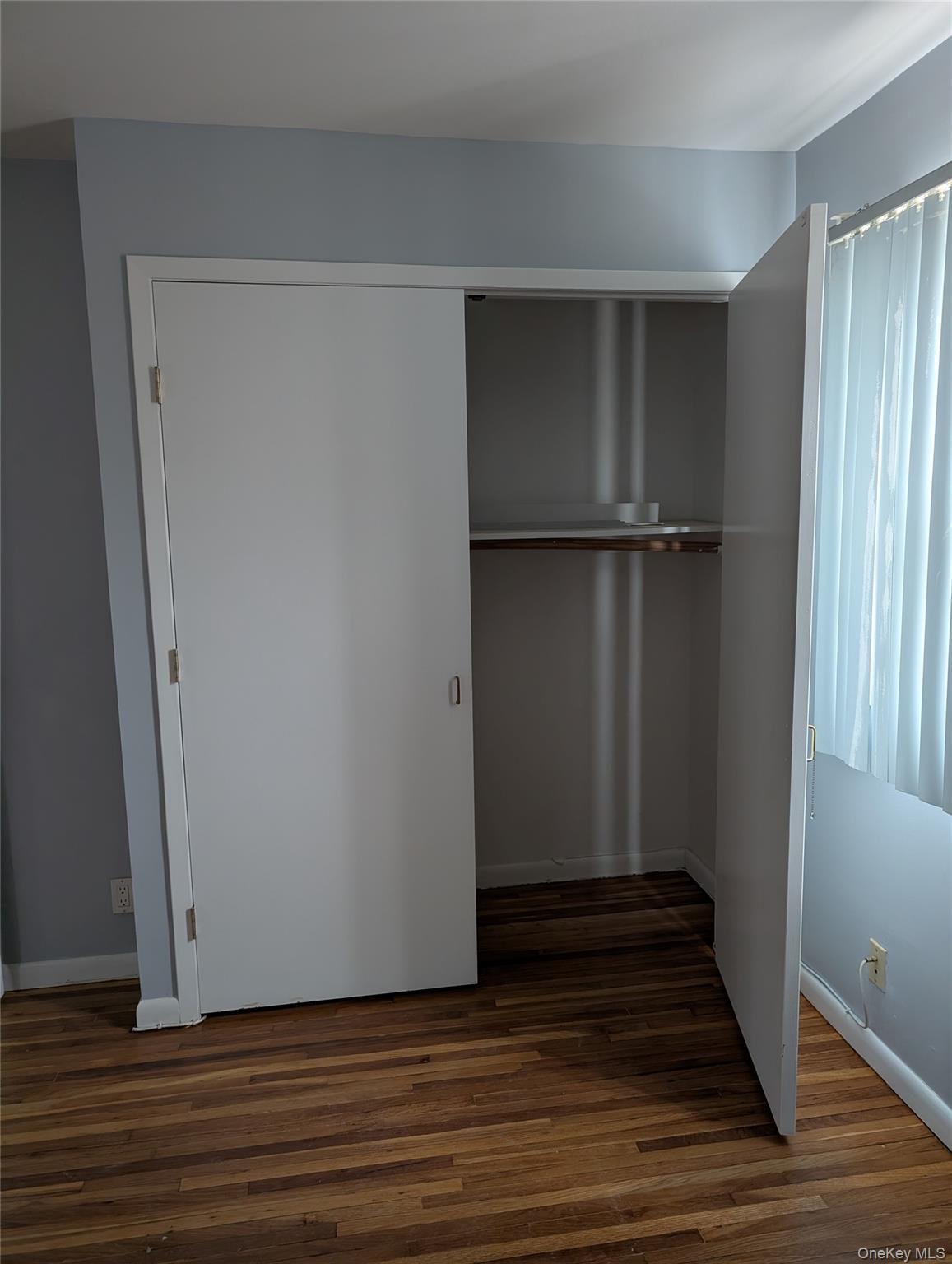 143-47 228th Street Queens, NY 11413 - Photo 8 of 18 a view of an empty room with wooden floor