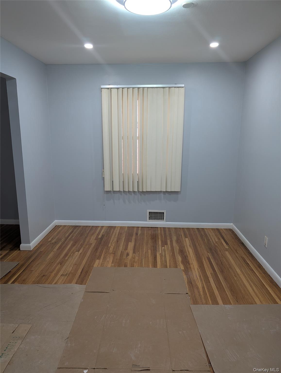 143-47 228th Street Queens, NY 11413 - Photo 9 of 18 an empty room with a bed and a window