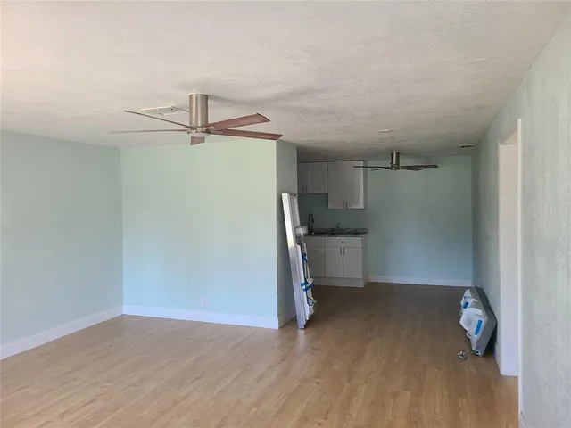 a view of a kitchen with a sink and cabinets