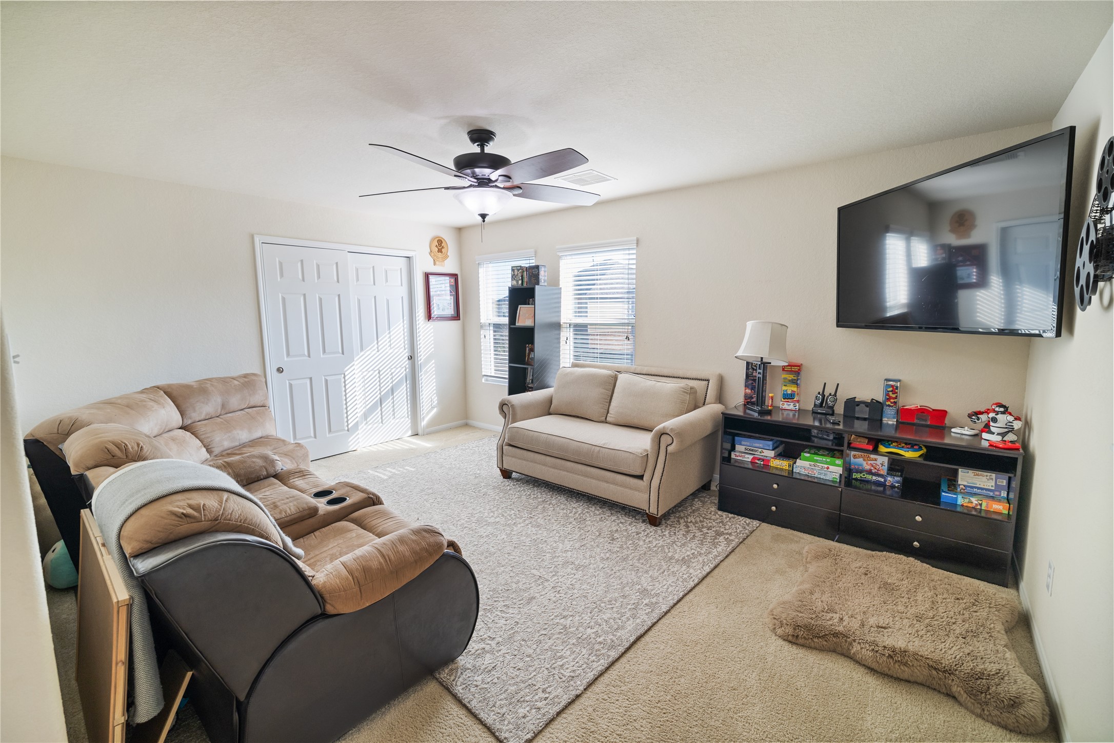 14906 Rustler Gate Lane Cypress, TX 77433 - Photo 15 of 30 a living room with furniture and a flat screen tv