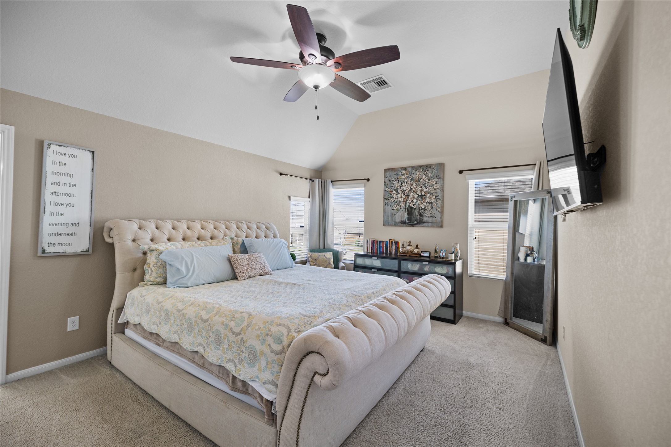 14906 Rustler Gate Lane Cypress, TX 77433 - Photo 17 of 30 a bedroom with a large bed and a chandelier