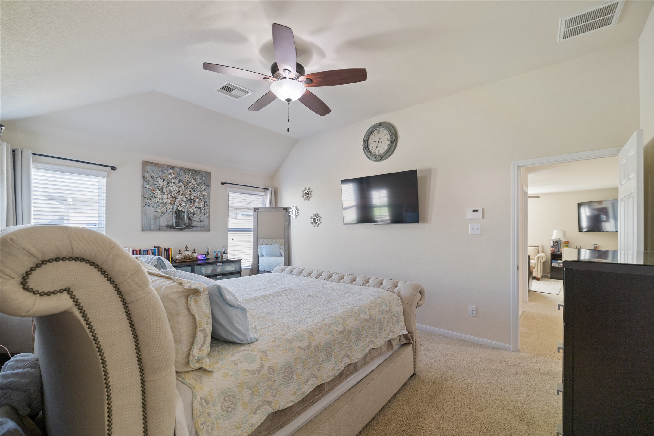 14906 Rustler Gate Lane Cypress, TX 77433 - Photo 19 of 30 a bedroom with a large bed and a flat screen tv