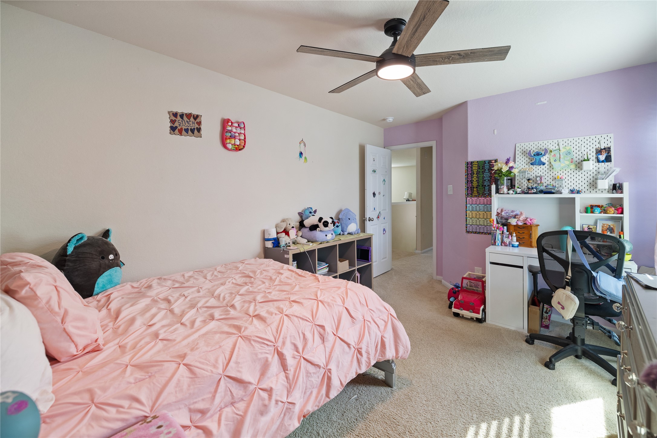 14906 Rustler Gate Lane Cypress, TX 77433 - Photo 23 of 30 a bedroom with a bed and a chandelier
