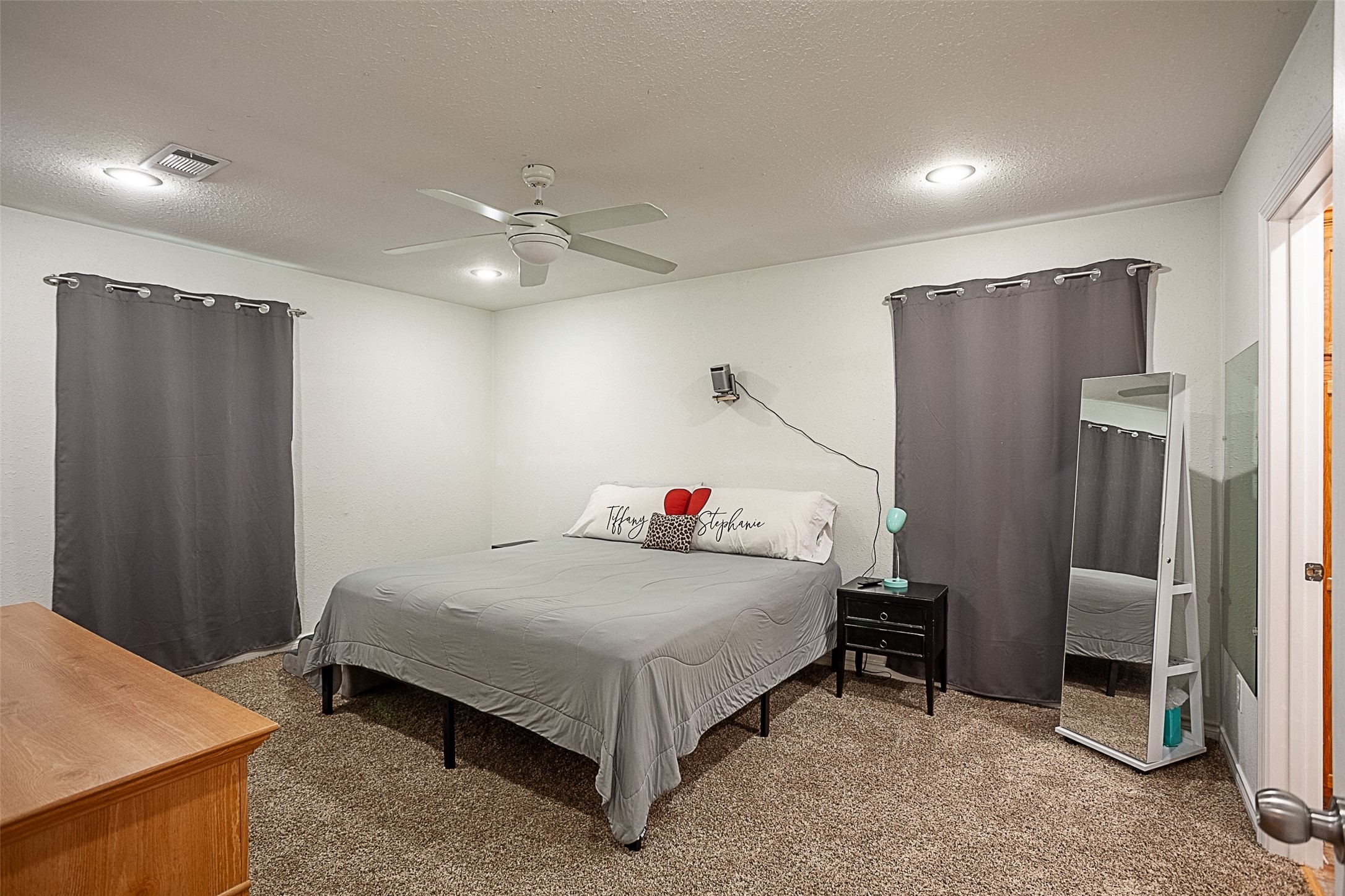 2704 62nd Street Port Arthur, TX 77640 - Photo 12 of 30 a bedroom with a bed and a refrigerator