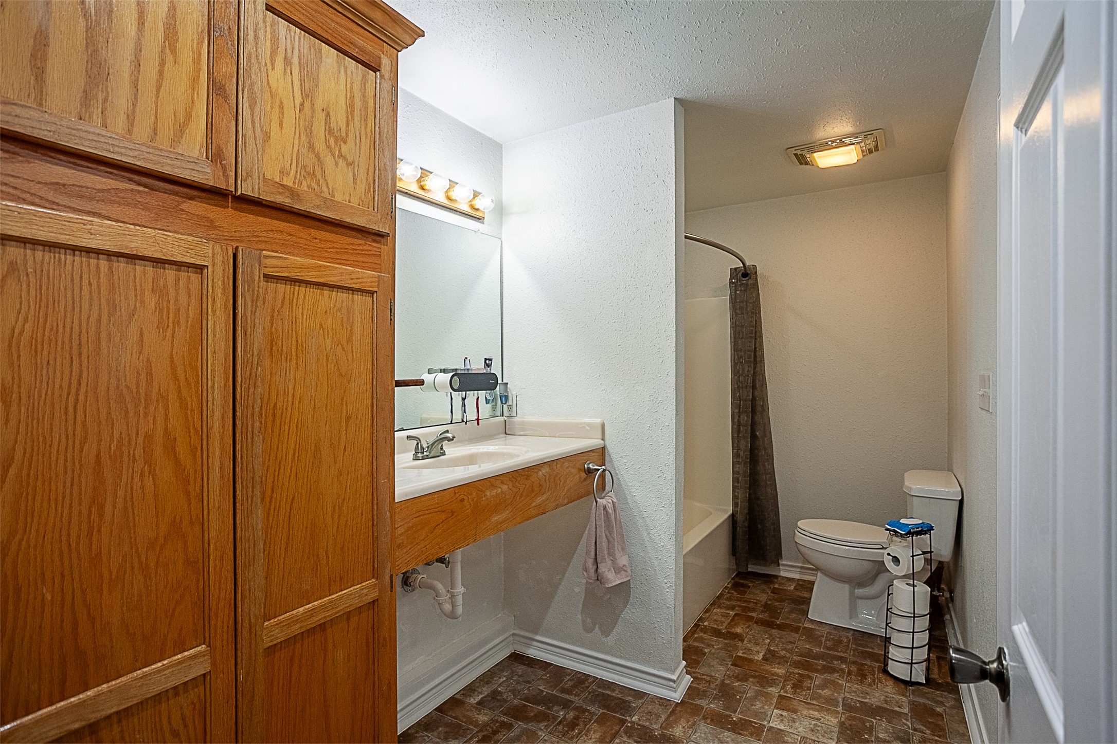 2704 62nd Street Port Arthur, TX 77640 - Photo 18 of 30 a bathroom with a sink a toilet and shower