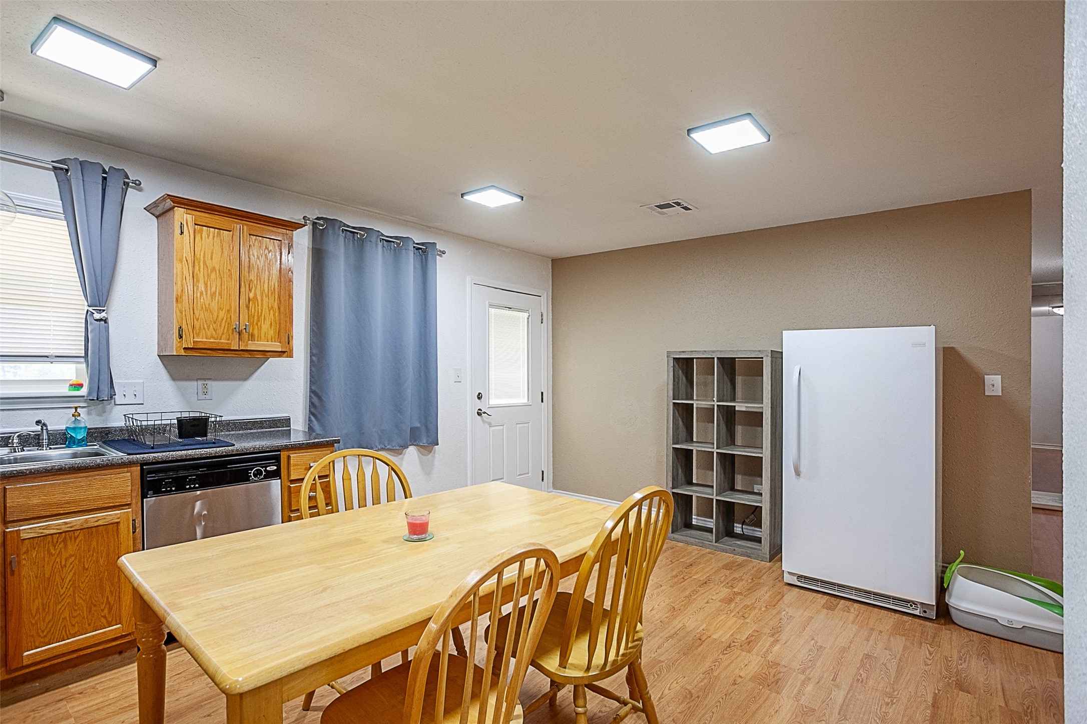 2704 62nd Street Port Arthur, TX 77640 - Photo 9 of 30 a kitchen with a table chairs refrigerator and cabinets