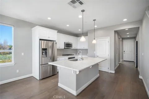 an empty space with wooden floor and ceiling fan