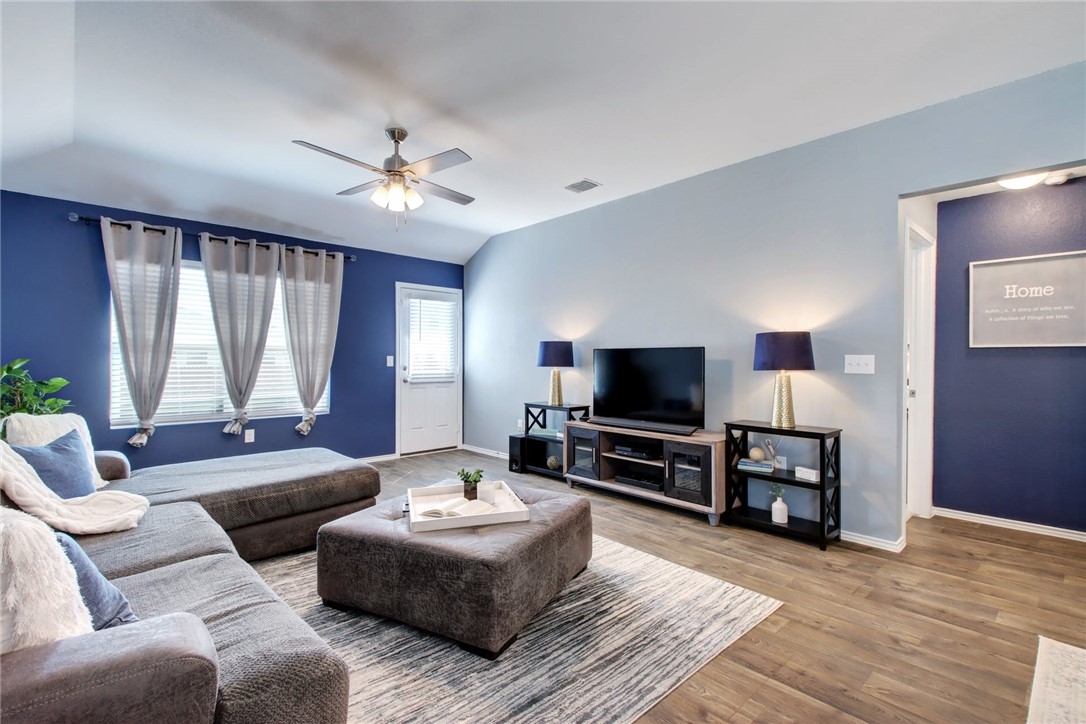 a living room with furniture and a flat screen tv