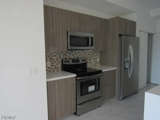 a kitchen with a stove and a microwave