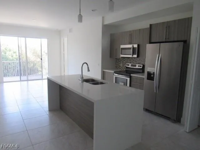 a kitchen with stainless steel appliances a refrigerator and a stove