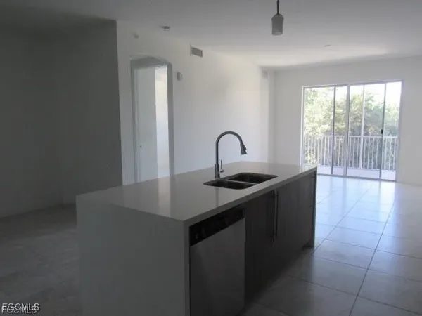 a kitchen with a sink a counter and a stove