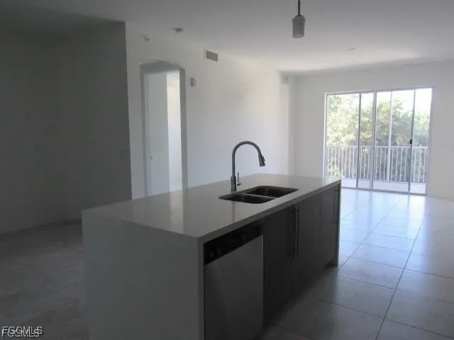 a kitchen with a sink a counter and a stove