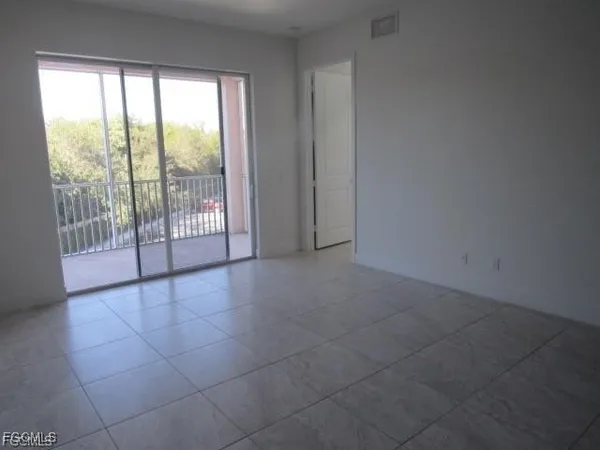 a view of an empty room with glass door